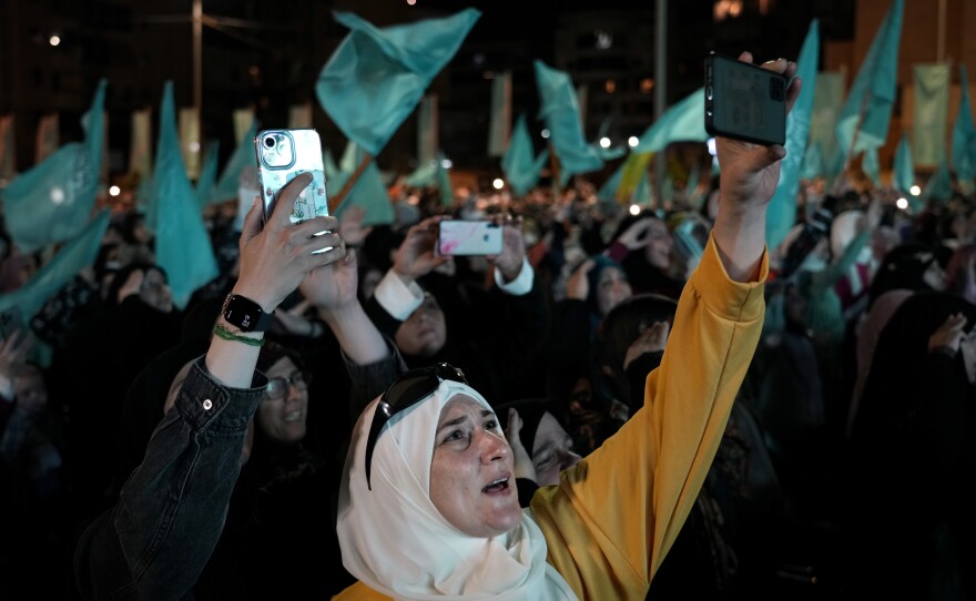 Hezbollah supporters listen to a speech by Hezbollah leader Sayyed Hassan Nasrallah via a video link, during a ceremony marking the Prophet Muhammad's birthday, in the southern Beirut suburb of Dahiyeh on Tuesday. Nasrallah said that the Iran-backed group will not comment on the closing of a maritime border deal between Lebanon and Israel until both parties sign the agreement.