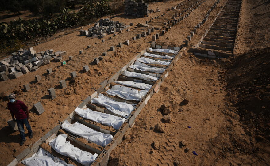 Bodies of unidentified Palestinians returned from Israel as part of a ceasefire deal are buried in a mass grave in Deir al-Balah, Gaza Strip, Nov. 5, 2025.
