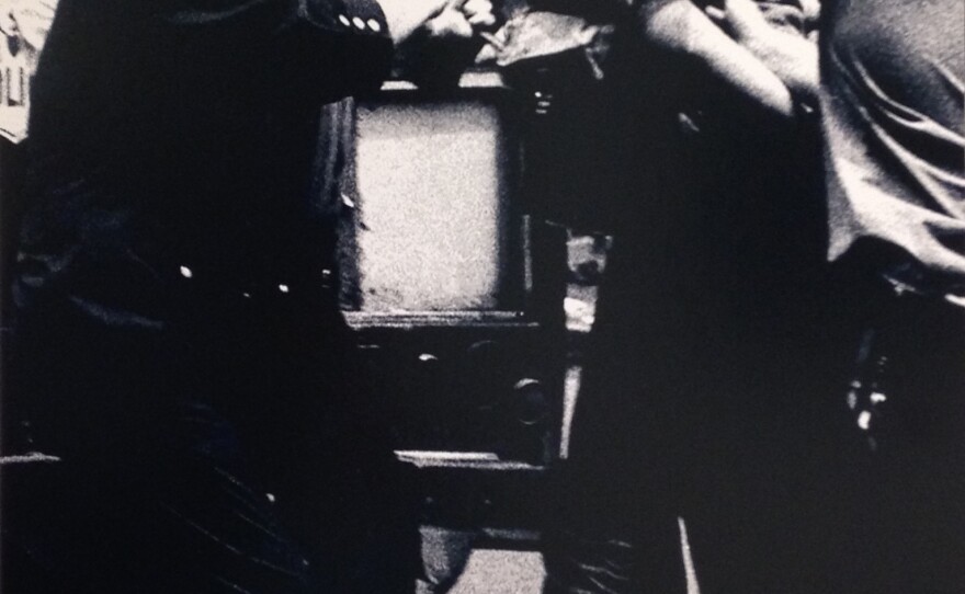 A member of the Young Lords with blood on his face is arrested by police. Bolivar Arellano took this photo, now on display at Columbia University, in 1971.