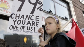 <p>Luoisiana Harris, 7, marches with Occupy Wall Street protesters from their base in Zuccotti Park toward Washington Square last Saturday. Harvard professor Lawrence Lessig says the Occupy Wall Street movement and the Tea Party share some similar concerns.</p>