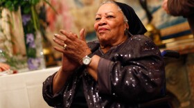 In this Sept. 21, 2012 file photo, U.S. novelist Toni Morrison applauds as she attends the America Festival at the U.S. embassy, in Paris.
