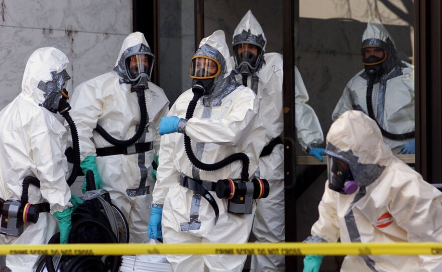 Hazardous materials experts enter the Hart Building of the U.S. Senate on Nov. 7, 2001, in Washington. The building was closed after an anthrax-laced letter was found in then-Sen. Tom Daschle's office.