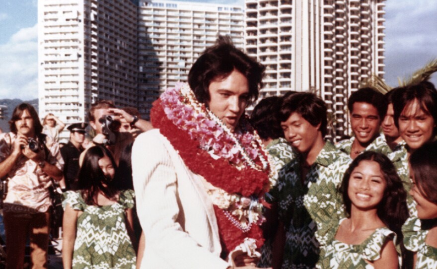 Elvis and fans, Hawaii. Elvis Presley made television history in 1973 with a live concert special, televised globally via satellite.