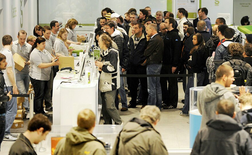 Customers line up Friday to buy Apple's new iPad as it is launched in Berlin.