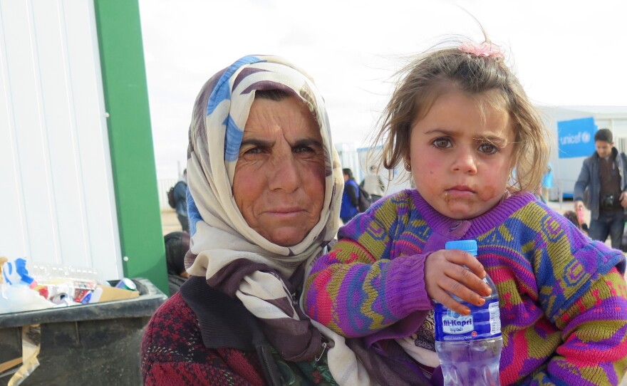 Enshera Mustafa holds her four-year-old granddaughter Nada outside a clinic near the Syrian-Jordanian border. Jordan sealed the border with Syria after a bombing last year and now allows a small number of refugees across for medical treatment before sending them back.