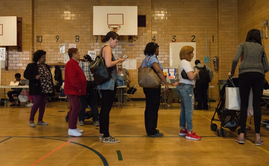 People line up to check in to their voting station at Public School 22 in Brooklyn on Tuesday.