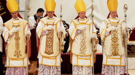Newly consecrated Bishops, from left, Marc Hanappier, Michel Poinsinet de Sivry, Michael Goldade and Pascal Schreiber wearing their miters and holding their pastoral staffs, stand at the end of their consecration ceremony in a tent set up outside the Society of St. Pius X seminary in Econe, Switzerland, Wednesday, July 1, 2026.