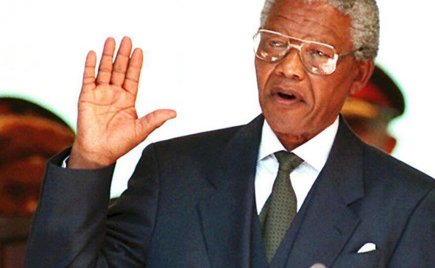 A file photo showing South African President Nelson Mandela taking the oath 10 May 1994 during his inauguration at the Union Building in Pretoria.