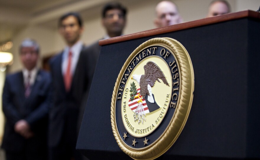 A U.S. Department of Justice seal is displayed on a podium during a news conference in 2012.
