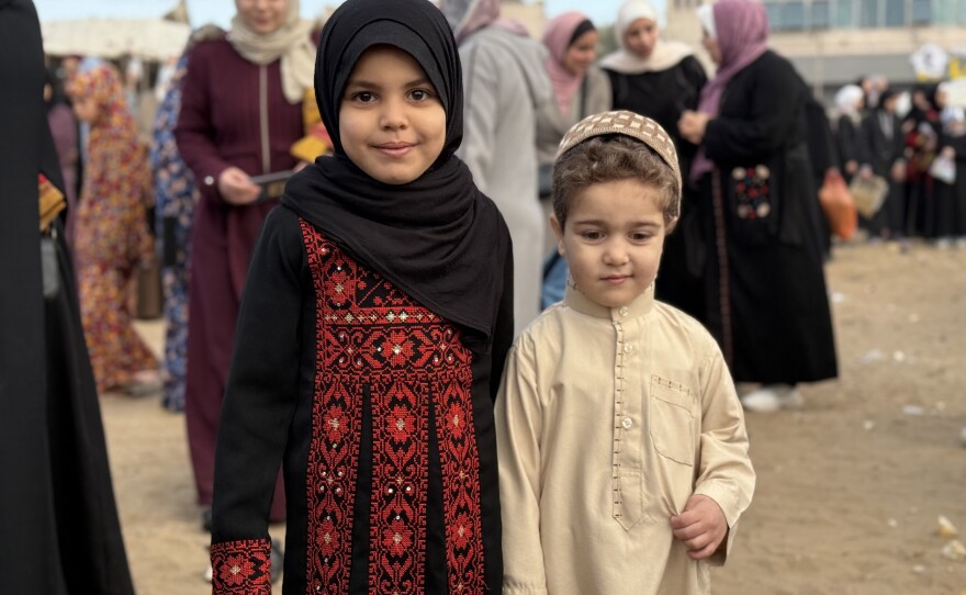 Children beamed in colorful new clothes for the Eid holiday.