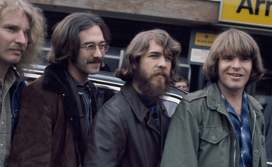 The original lineup of Creedence Clearwater Revival, at London's Heathrow Airport. L-R: Tom Fogerty, Stu Cook, Doug Clifford, John Fogerty.