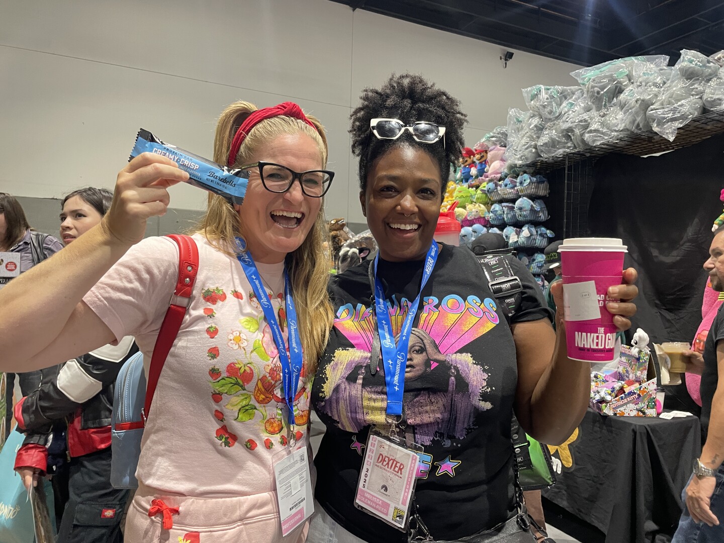 Sam Ginn and Melissa Coleman-Reed display their Comic-Con survival snacks: a protein bar for Ginn and coffee for Coleman-Reed in this undated photo.