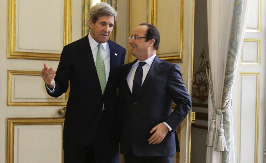 John Kerry, on his first trip abroad as secretary of state, walks with French President Francois Hollande after their meeting at Elysee Palace in Paris on Feb. 27. Kerry's nine-day trip took him through Europe and the Middle East.