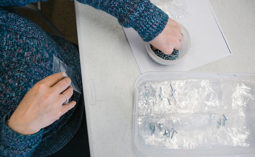 Pauline puts together a small bag with two screws each for Arlington Industries as a part of prevocational skills training during a day program at the Arc Northeastern Pennsylvania.