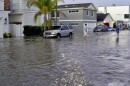 Streets and homes flooded in Newport Beach, Calif., during a high tide in July 2020. So-called sunny day floods are getting more common in coastal cities and towns as sea levels rise due to climate change.