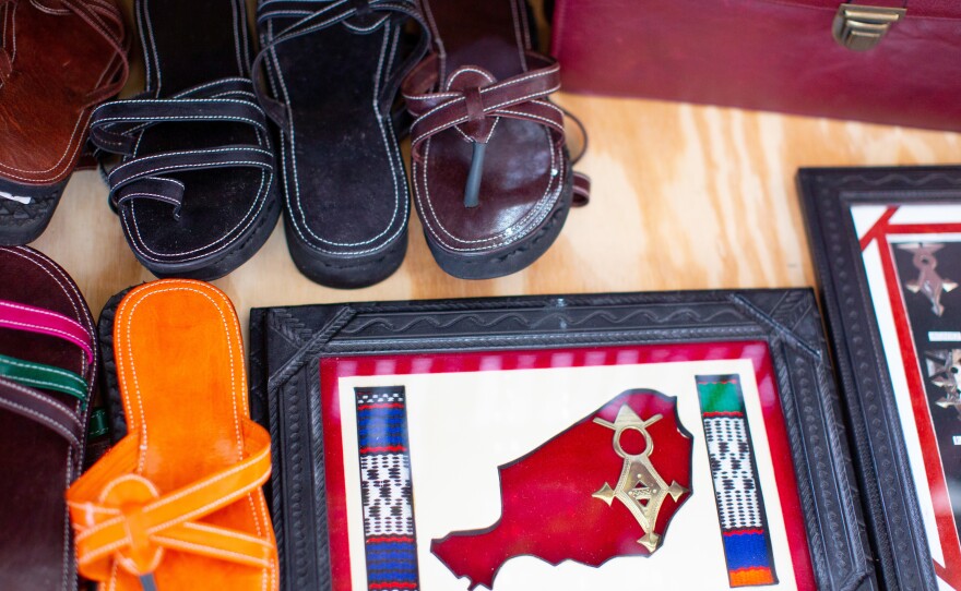 Leather sandals, made by Saley, on display along with other items.