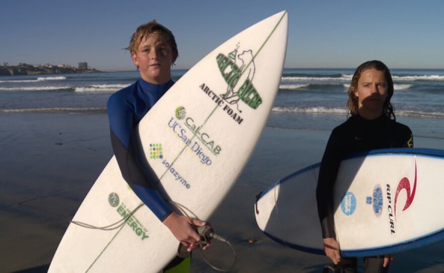 Two young San Diego surfers give the algae foam surfboard a try in the breakers off La Jolla Shores, La Jolla, San Diego, Calif.