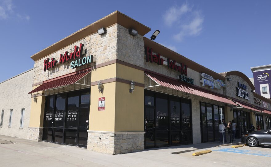 Authorities have said a man dressed all in black opened fire at the Hair World Salon on Wednesday, wounding three women, then drove off in a maroon minivan. A suspect has been arrested in the shooting, police said Tuesday.