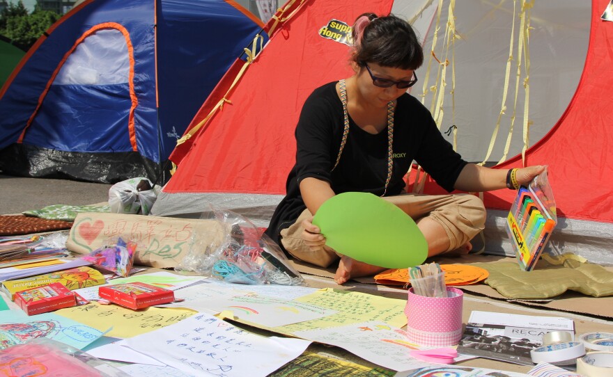 Map Tang, a social worker, has set up an art therapy center at her tent. She says protesters are exhausted after three weeks of demonstrations and need a way to express their feelings.