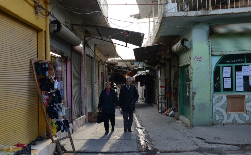 An Assyrian Christian couple walks through the market area of al-Qosh, where most residents have returned after fleeing last August in the face of an advance of the Islamic State. The ancient village is about 30 miles north of Mosul, Iraq's second biggest city, which is still held by the Islamic State.