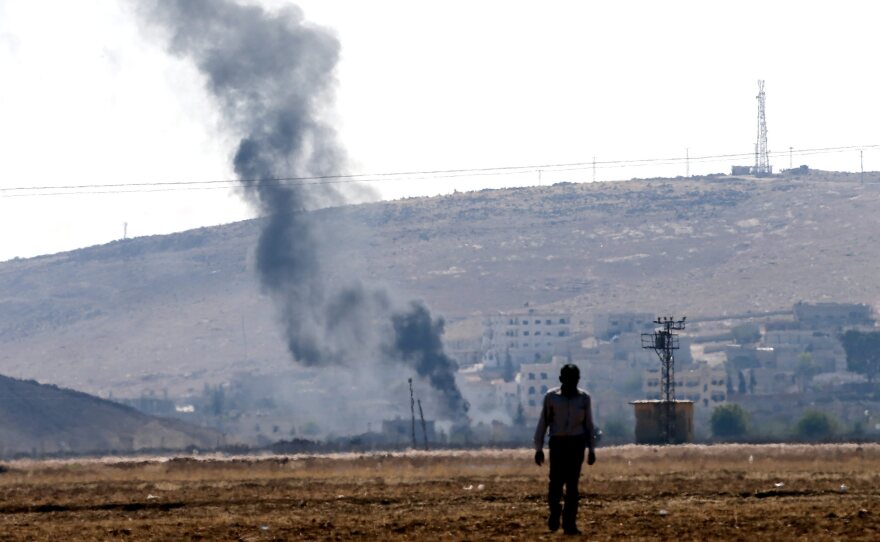 Smoke rises from buildings in Syria's Kobani city on the Turkish-Syrian border, near Sanliurfa, on Monday.
