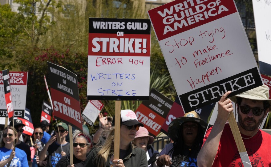 Members of the Writers Guild of America, WGA picket outside CBS Television City in the Fairfax District of Los Angeles Tuesday, May 2, 2023. The first Hollywood strike in 15 years began Tuesday as the economic pressures of the streaming era prompted unionized TV and film writers to picket for better pay outside major studios, a work stoppage that already is leading most late-night shows to air reruns.