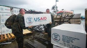 Hospital Corpsman 3rd Class Eric Chiarito, left, and Marine Sgt. Jonathan Thornton load supplies at Tacloban Air Base in support of Operation Damayan. 