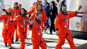 Space Shuttle Atlantis STS-125 astronauts, (R-L) commander Scott Altman, pilot Greg Johnson, mission specialists Megan McArthur, mission specialists John Grunsfeld, Mission Specialist Andrew J. Feustel, and mission specialist Michael T. Good wave as they prepare to head to the launch pad for a 2:01pm launch today at Kennedy Space Center on May 11, 2009 in Cape Canaveral, Florida. 