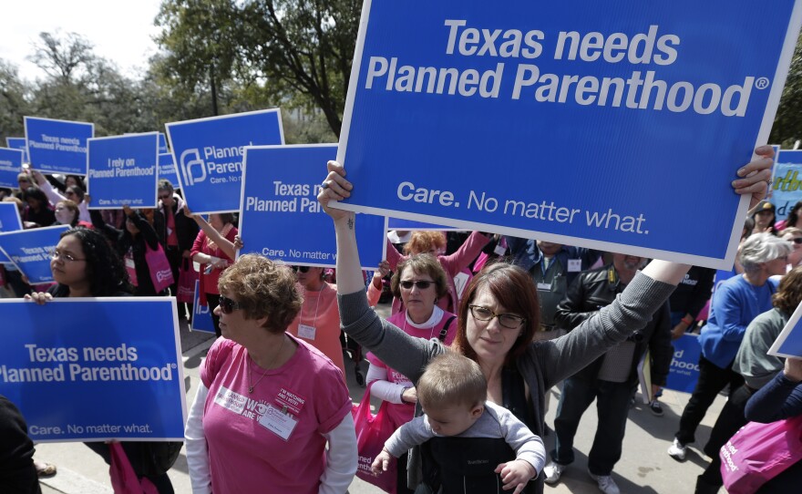 Five-month-old Ronan Amador rides in a carrier with his mother, Elizabeth Mahoney, during a Planned Parenthood rally on the steps of the Texas Capitol on March 7, 2013, in Austin.