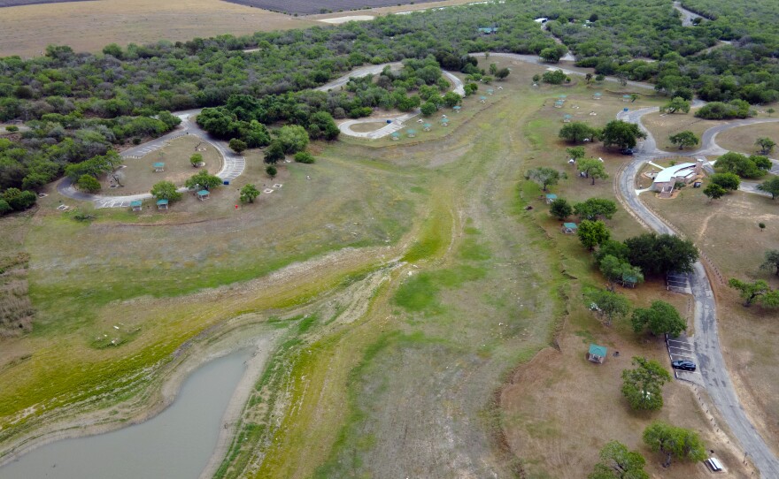 A top-down aerial view of Lake Corpus Christi reveals dry lakebed and shrinking water levels as drought continues to strain the region's supply on April 10, 2026. 