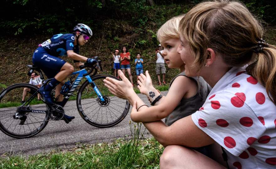 Fans watch from the roadside as Movistar cyclist Paula Andrea Patino of Colombia rides in the seventh stage of the Tour de France Femmes avec Zwift.