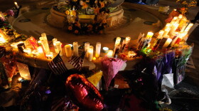 Mourners create a memorial at the fountain of the Aurora Municipal Center after a prayer vigil Sunday for the 12 victims of Friday's mass shooting at the Century 16 movie theater.