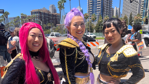Cosplayers dress as HUNTR/X, the K-pop trio from Netflix's "K-Pop Demon Hunters," at Comic-Con on July 26, 2025. The group — Mira, Rumi and Zoey — double as demon hunters in secret.