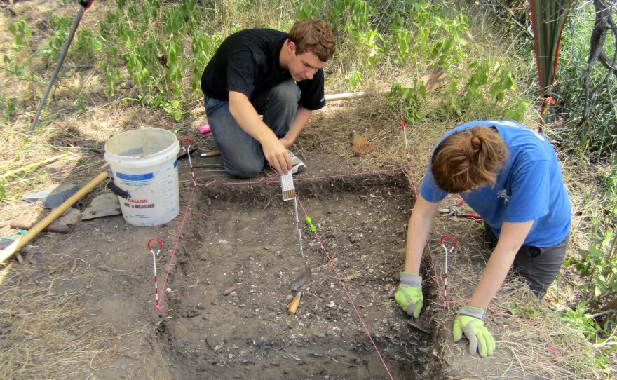 Members of the research team, Sean McCanty and Courtney Hofman, excavate an ancient oyster shell midden at the Smithsonian Environmental Research Center in Edgewater, Md.