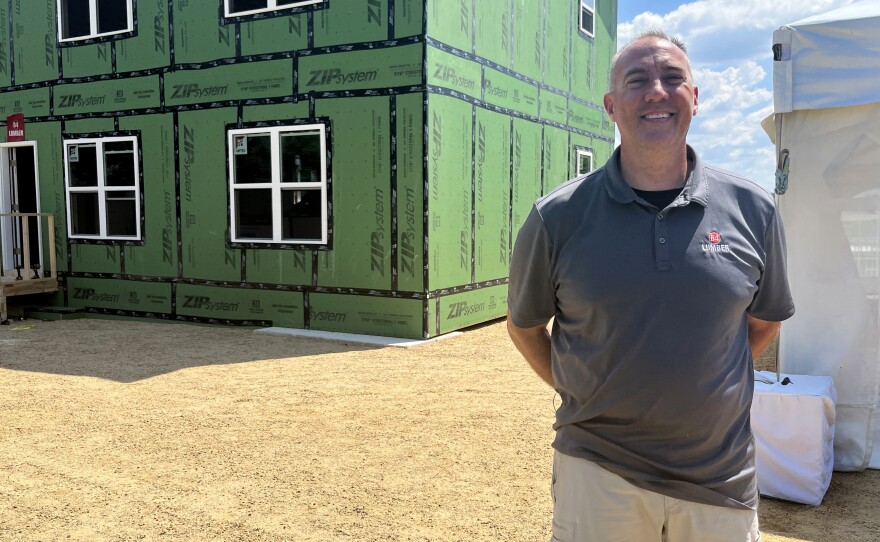 Mark Cyrus, who works for 84 Lumber, stands in front of a home that that was framed in about six hours using prebuilt materials — a job that often takes two weeks with traditional materials.