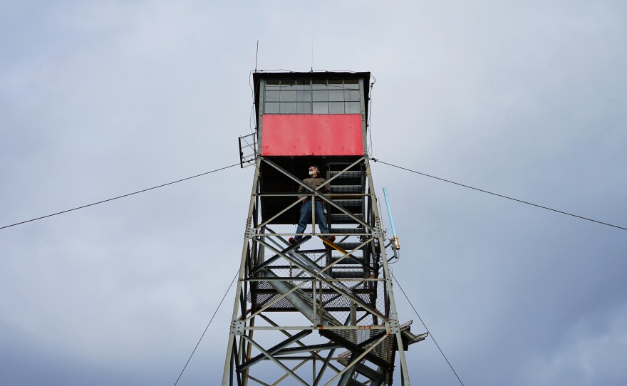 Connors stands in the lookout tower. In recent years, the number of active lookouts has dwindled from thousands to hundreds as technology has encroached.