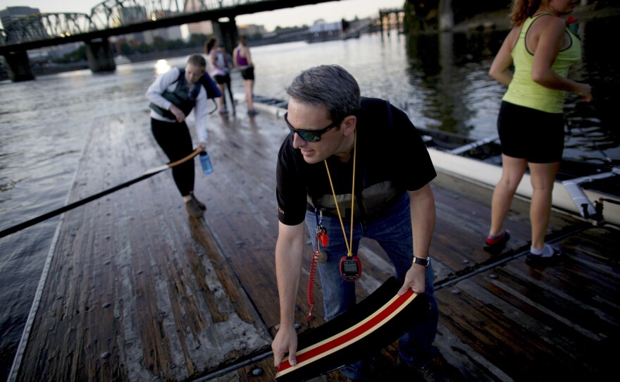 After practice, Haley helps students bring the boats up onto the dock.