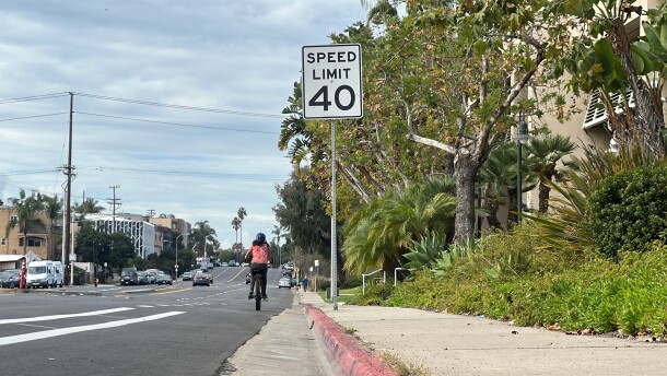 A cyclist rides past a 40 mph speed limit sign on West Point Loma Boulevard, Nov. 29, 2023.