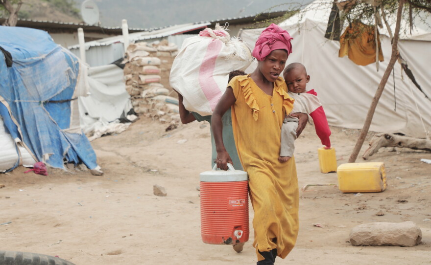 A displaced person walks through a camp in Taiz province, Yemen, Tuesday, Sept. 15, 2026.
