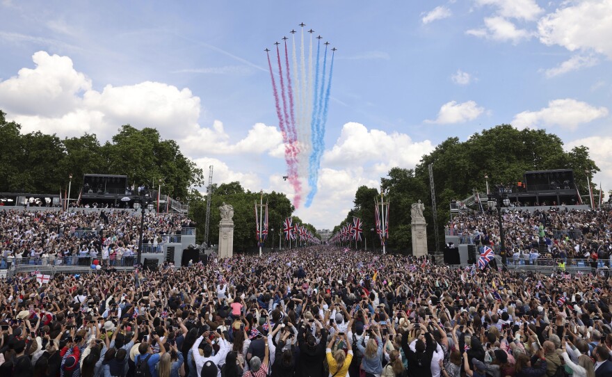 The red arrows fly over the crowd as they wait for the royal family to appear on a Buckingham Palace balcony.
