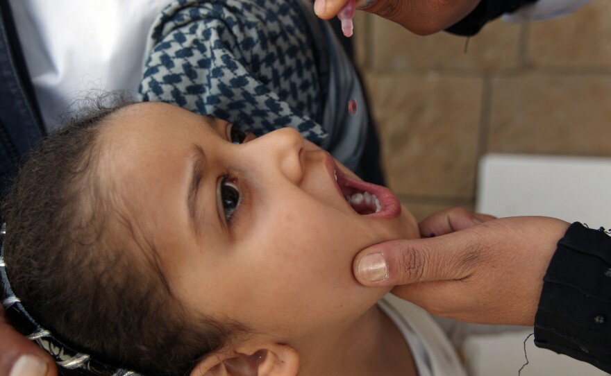 A Yemeni child receives a polio vaccine in the capital city of Sanaa. The Yemen government launched an immunization campaign last month in response to the polio outbreak in neighboring Somalia.