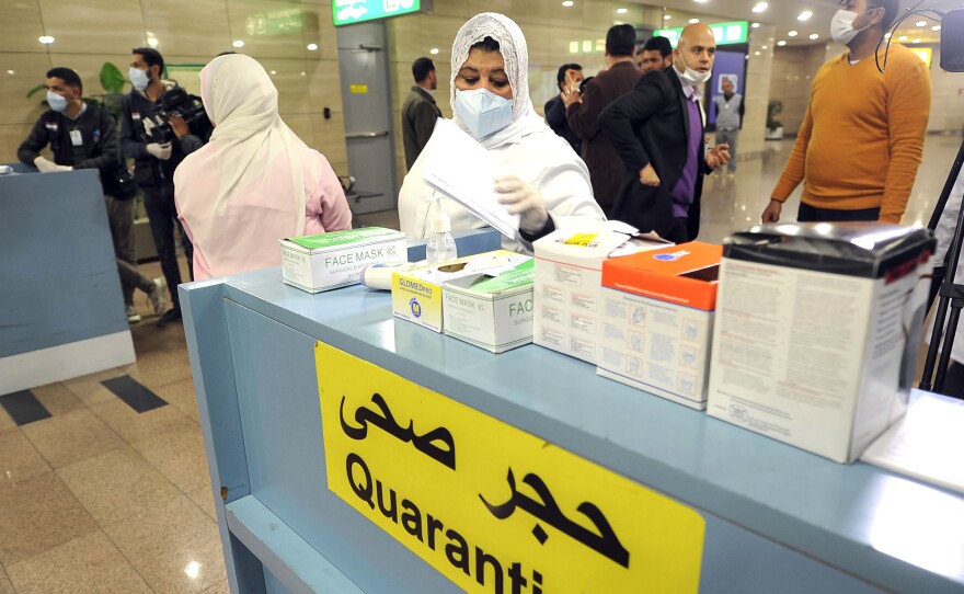 Employees of the Egyptian Quarantine Authority prepare to scan the body temperature of incoming travelers at Cairo International Airport.