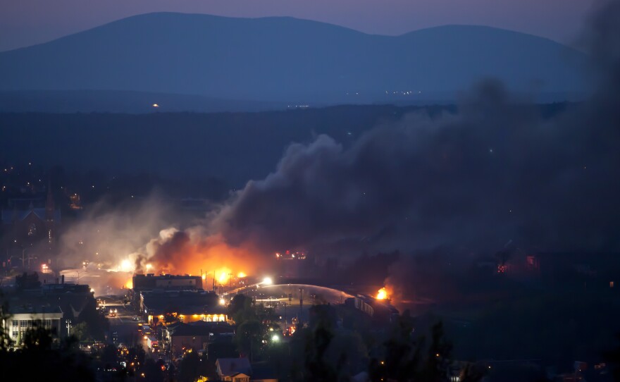 Firefighters douse blazes after a freight train loaded with oil derailed in Lac-Megantic, Quebec, last July.