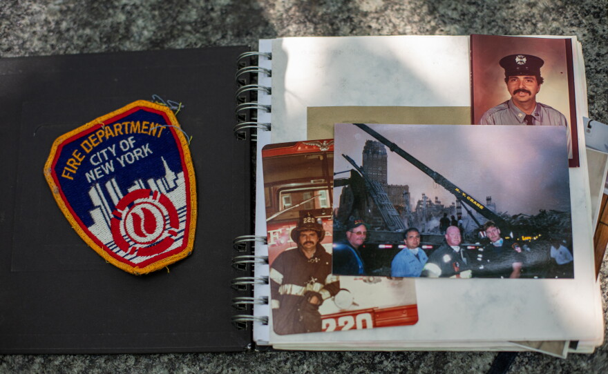 Photographs and a patch that belong to Rocco Fertoli are seen in a family album. Fertoli lost dozens of colleagues and friends on Sept. 11, 2001, and many more have succumbed to illnesses related to the tragedy in the intervening years.
