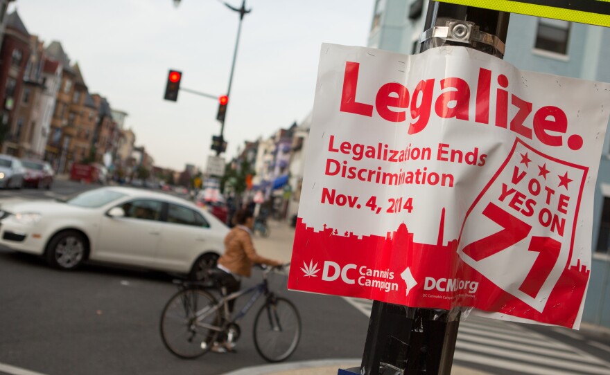 Early results showed more than a 2-1 lead for a measure to make recreational marijuana use legal in Washington, D.C. A sign promoting the initiative is seen on a corner in the Adams Morgan neighborhood Tuesday.