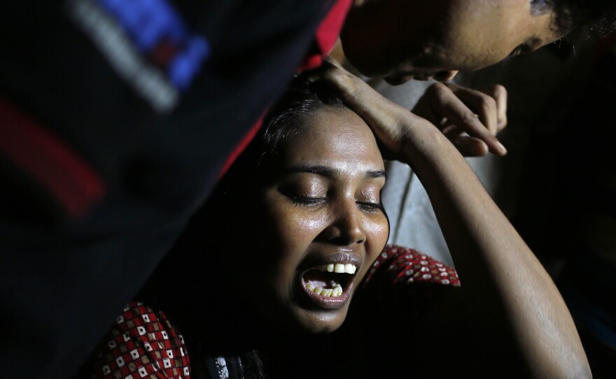 Ashamoni, wife of blogger Niloy Chakrabati, cries at her house in Dhaka, Bangladesh, on Friday after her secular activist husband was hacked to death by suspected Islamist extremists.