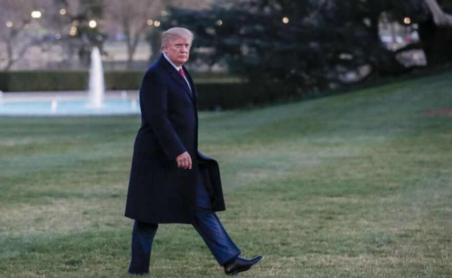 President Trump walks across the South Lawn toward the White House on Sunday.