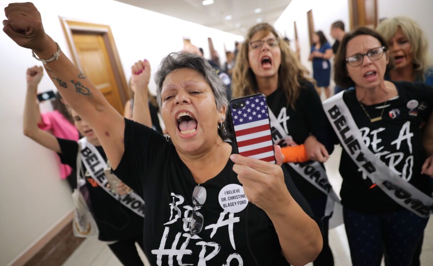 Dozens of protesters, including sexual assault survivor Mary Jane Maestras of Delta, Colo., demonstrate against the appointment of Supreme Court nominee Judge Brett Kavanaugh.