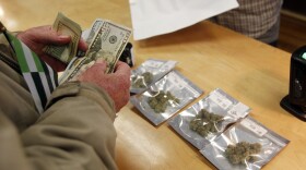 A customer, who declined to give his name, waits for his order to be filled at Harborside marijuana dispensary in Oakland, Monday, Jan. 1, 2018.