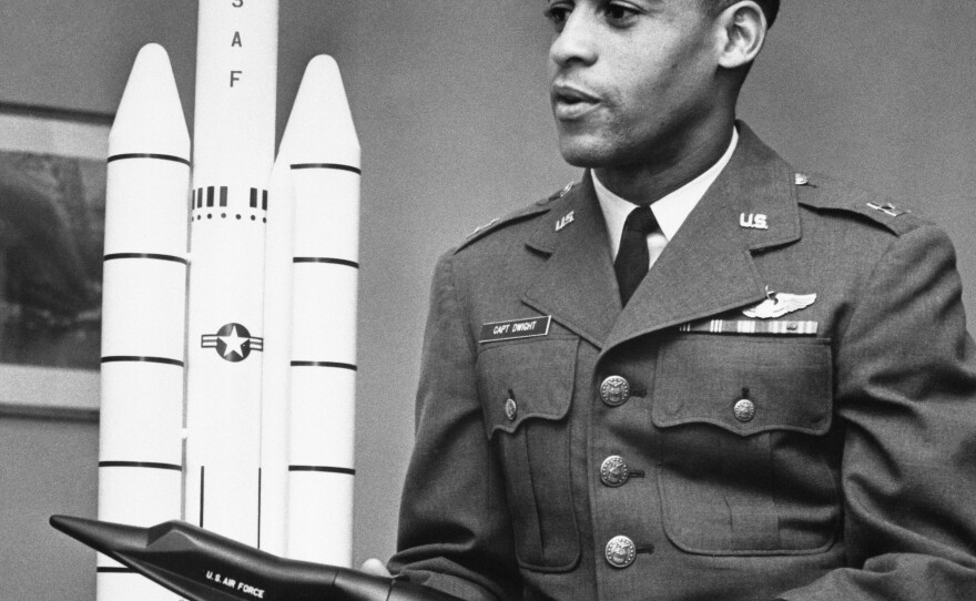 Air Force Capt. Edward J. Dwight Jr., the first African American selected as a potential astronaut, looks over a model of the Titan III-X-20 Dyna-Soar combination during a visit to Air Force headquarters in the capital in November 1963.